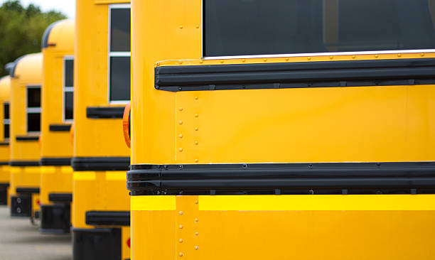 istock Line of Yellow School busses (Close-Up) 515962799