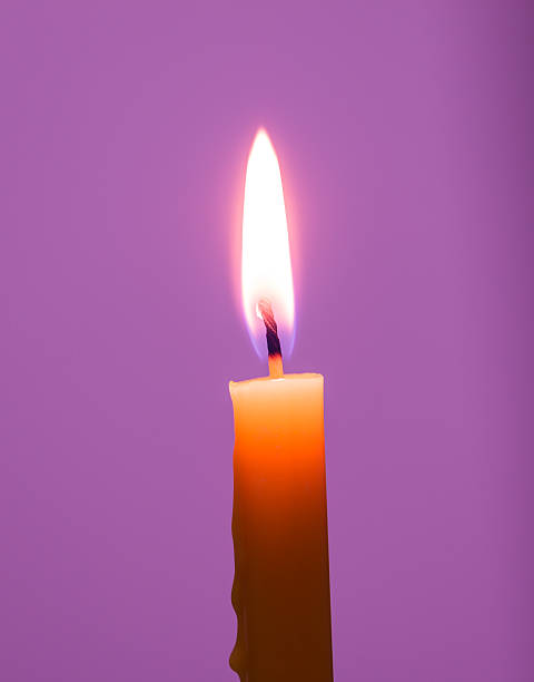 istock yellow Candle on Purple background 515963227
