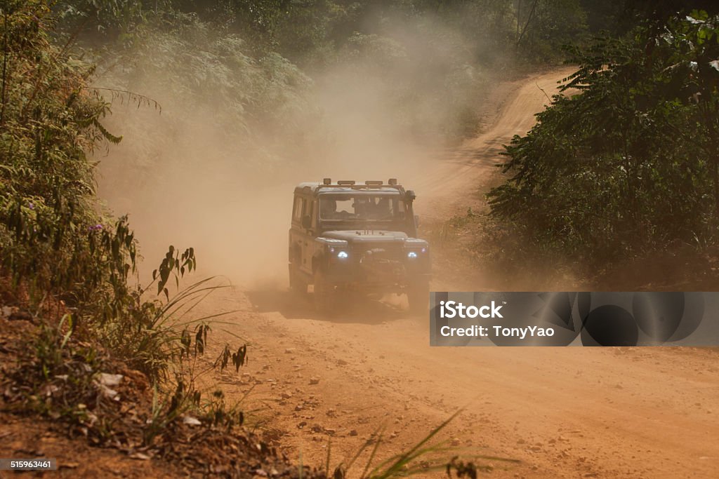 Off road SUV vehicle running in forest Off road SUV vehicle running in forest on road 4x4 Stock Photo