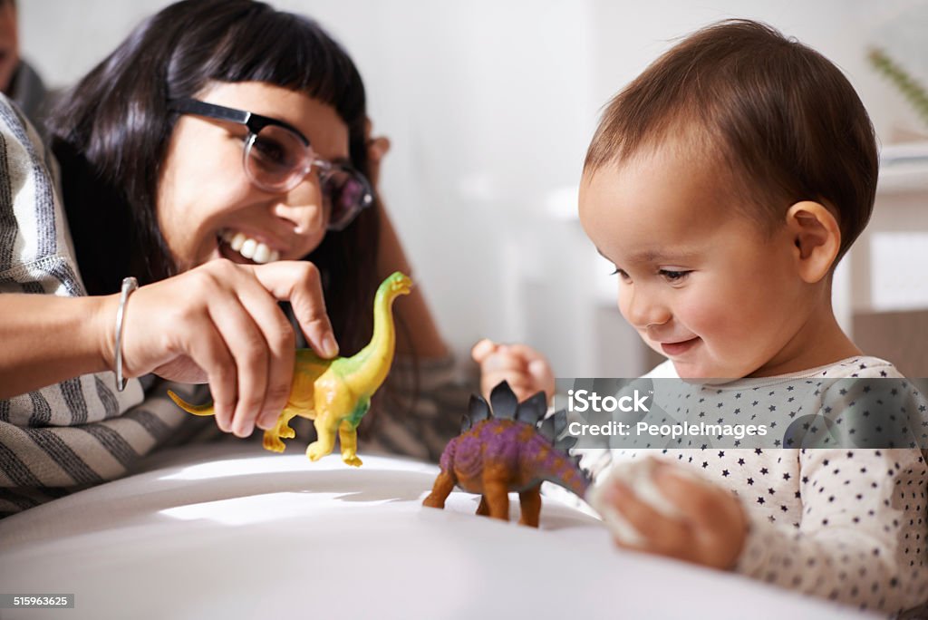 We play, learn and grow together Shot of a happy mother playing with her daughter and toys Playing Stock Photo
