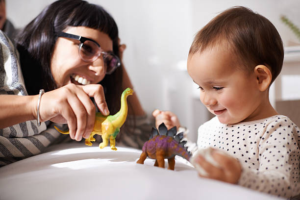 We play, learn and grow together Shot of a happy mother playing with her daughter and toys leanincollection stock pictures, royalty-free photos & images