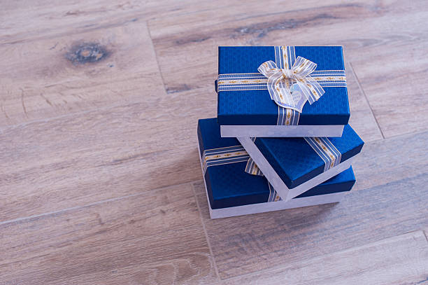 istock three blue boxes on the surface of light wood 515964682