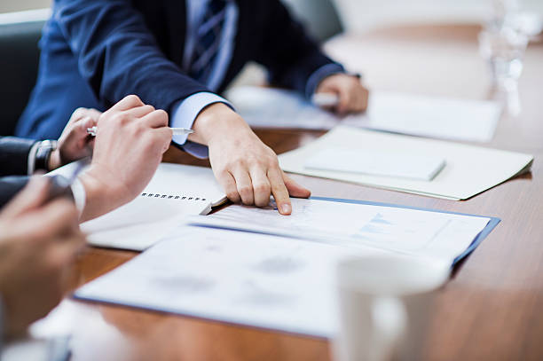 Close-up of a businessmans hand Three businessmen meeting in a conference room. career vitality stock pictures, royalty-free photos & images