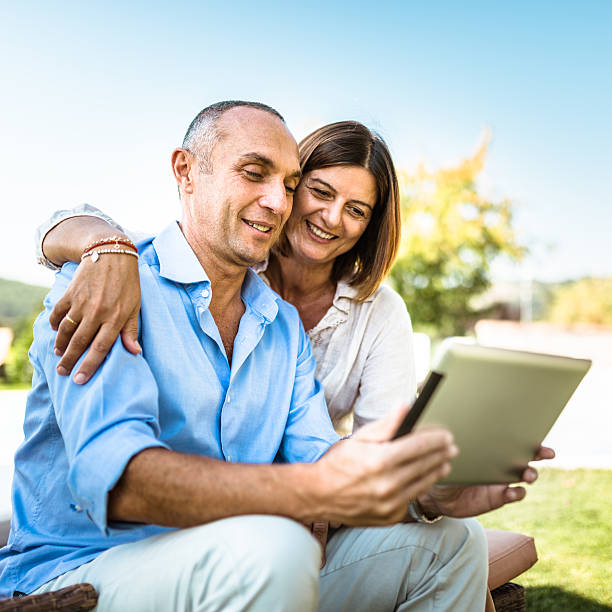 istock happiness mature couple embracing and surfing 515965382