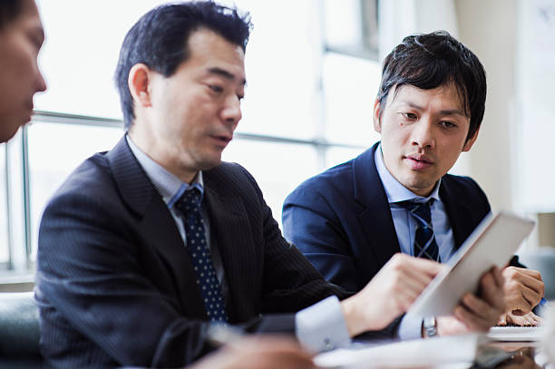 istock Three businessmen meeting using digital tablet in a conference room. 515965982