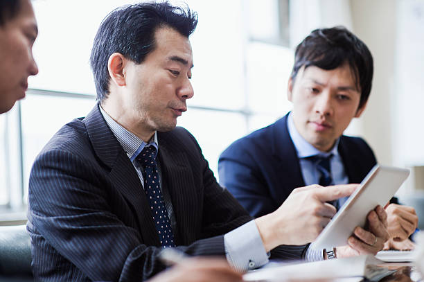 istock Three businessmen meeting using digital tablet in a conference room. 515966050