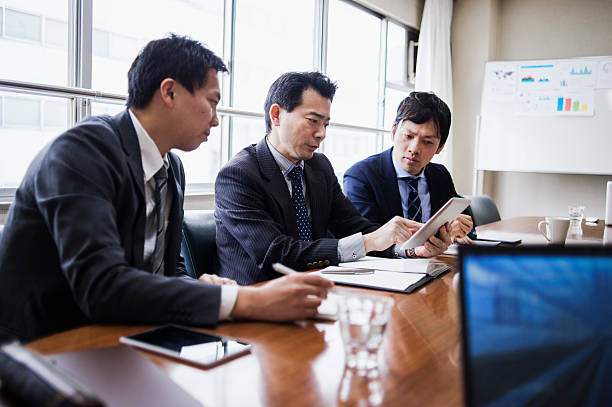 istock Three businessmen meeting using digital tablet in a conference room. 515966226