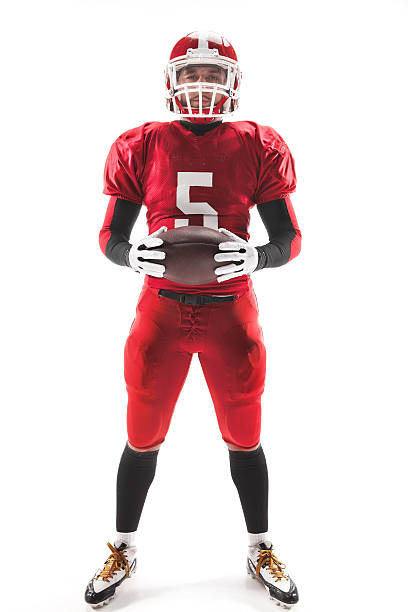 istock American football player posing with ball on white background 515966518
