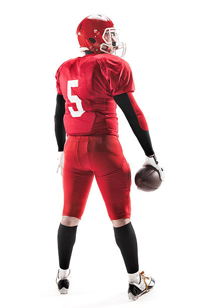 istock American football player posing with ball on white background 515966820