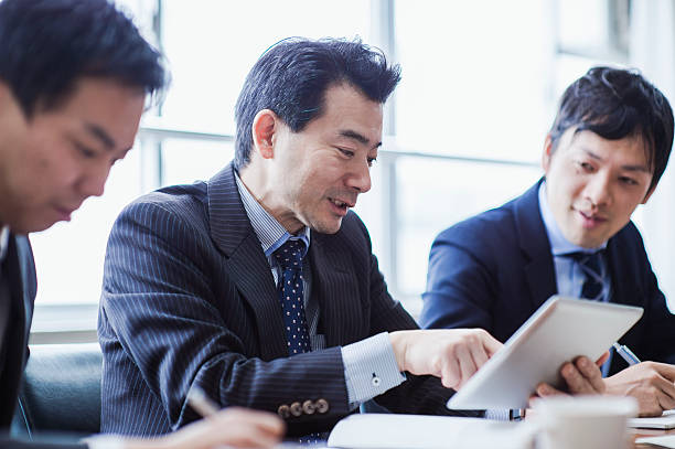 istock Three businessmen meeting in a conference room. 515966980