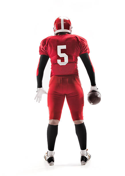 The back view of caucasian fitness man as american football player holding a ball on white background