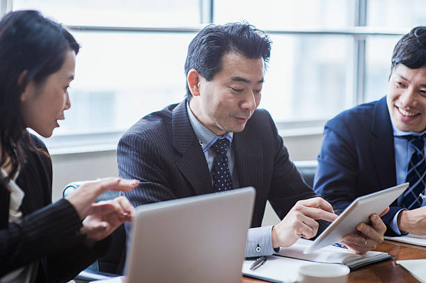 istock Three businesspeople meeting in a conference room. 515967152