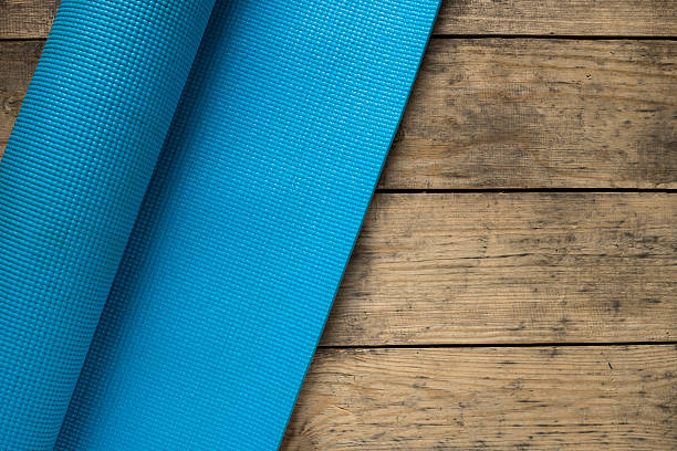 istock Yoga mat on old wood table 515968134