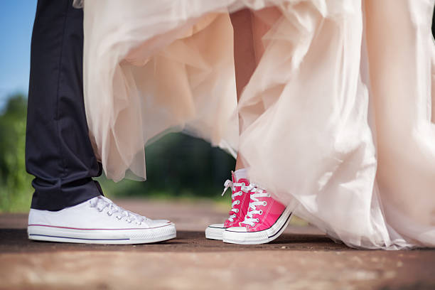 istock Bride's and groom's legs with sneakers 515969136