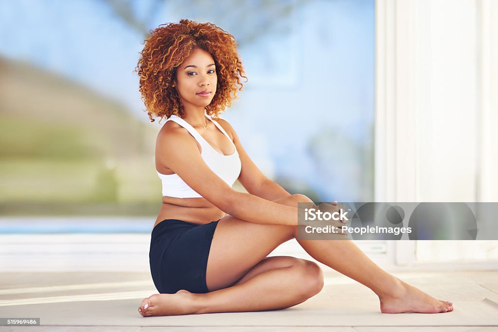 Being healthy and fit is a lifestyle Shot of a sporty young woman sitting on the floor 20-29 Years Stock Photo