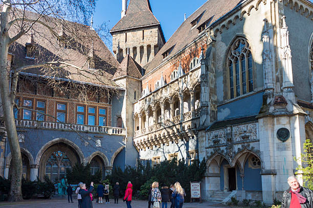 Budapest, Hungary, March 14 2016: Early tourists starting to gather at the Vajdahunyad Castle in Budapest, Hungary