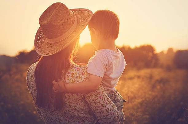 istock Mother and a baby enjoying beautiful sunset 515972296