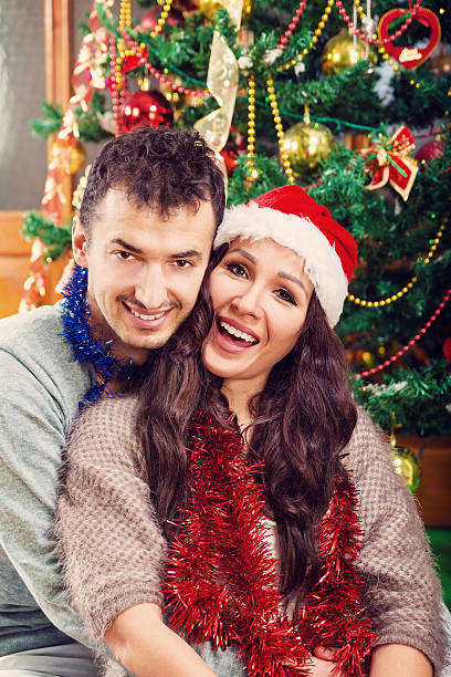 istock Young man holding his girlfriend in his arms on Christmas 515972770