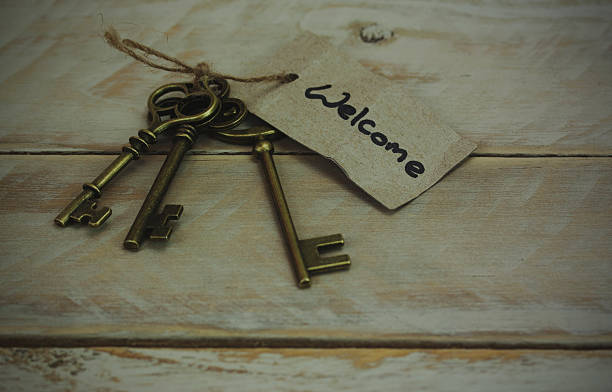 istock Antique keys on wooden background 515976448