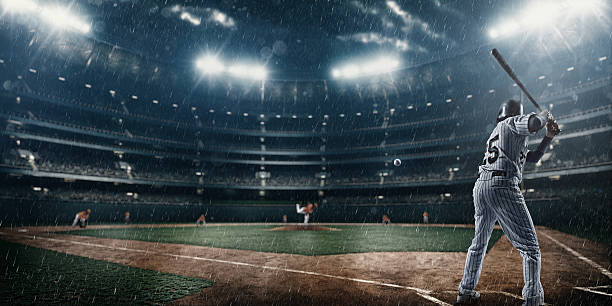 Baseball game A moment of baseball game  on a baseball stadium under dramatic stormy skies and rain. batting sports activity stock pictures, royalty-free photos & images