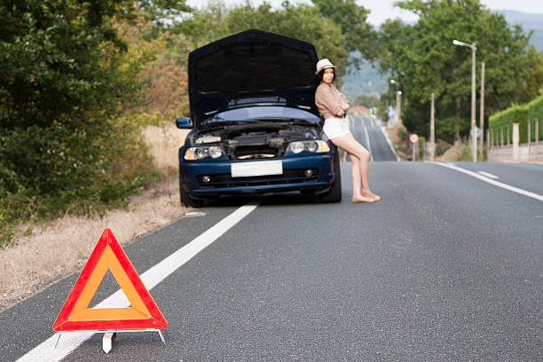istock girl with broken car on the road 516000354