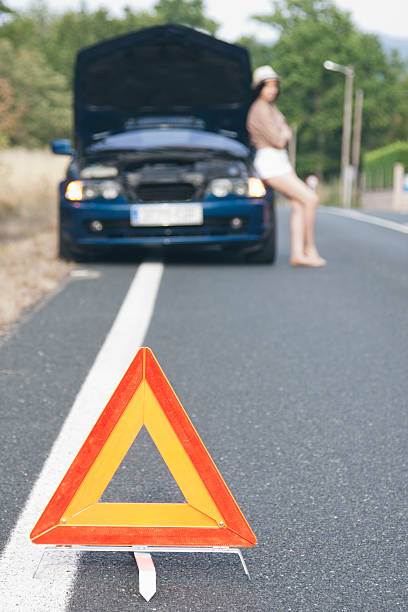 istock girl with broken car on the road 516001072