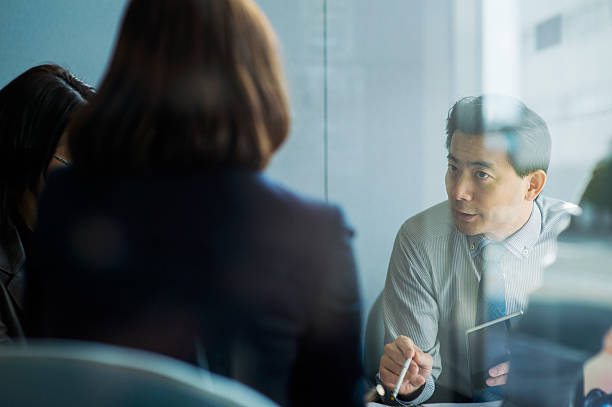 Business team working in office Business Workers having a meeting in the office of the entrance.Shooting of a glass of reflection in pride we trust stock pictures, royalty-free photos & images