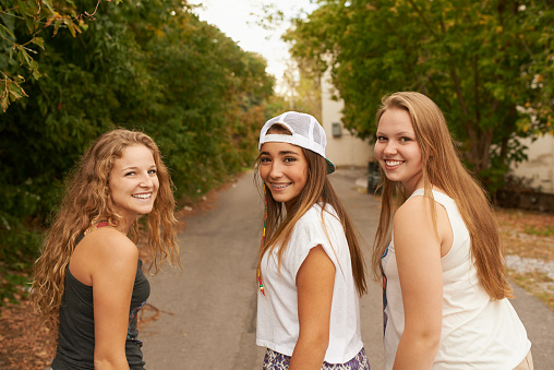 Shot of three teenage girls walking down the street