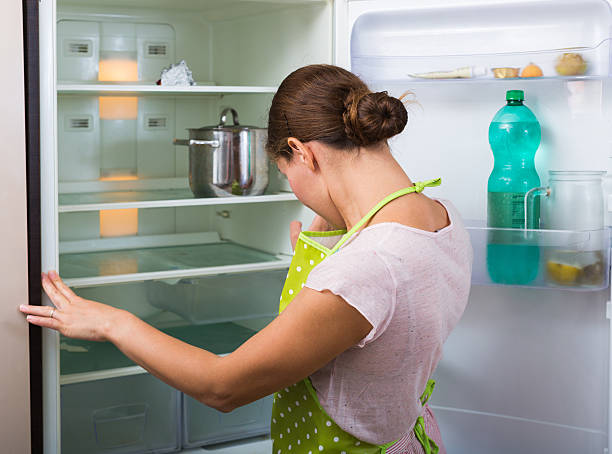 istock Woman near empty fridge 516004252