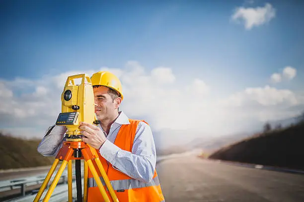 Photo of Land surveyor with total station