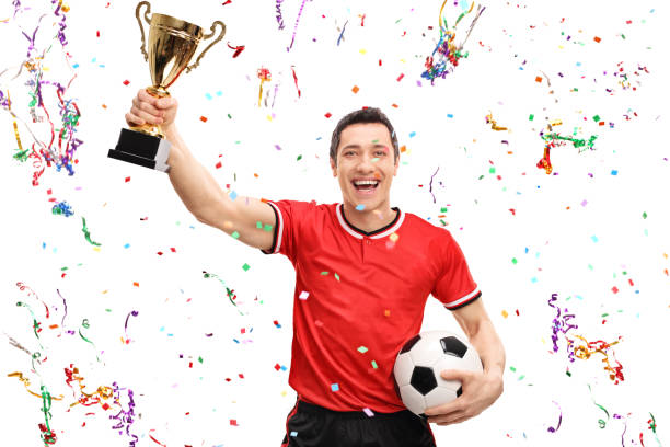 istock Joyful football player holding a trophy 516004982