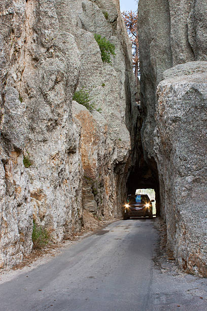 istock Vehicle Traveling Through Tight Rock Tunnel 516006648