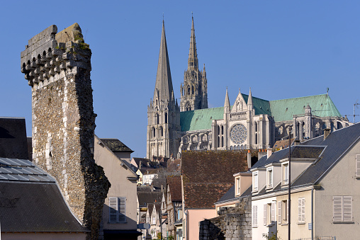 Cathedral Notre-Dame of Chartres with old vestige of the Porte Guillaume. Chartres is a commune and capital of the Eure-et-Loir department in region Centre-Val de Loire in France. Chartres is well known for its cathedral