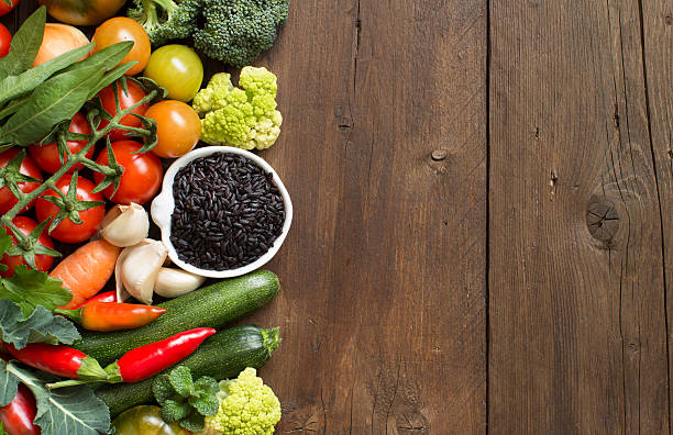 istock Uncooked black rice in a bowl with vegetables 516007380