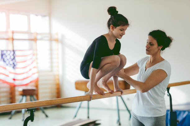 istock Girl exercising on uneven bars. 516010206