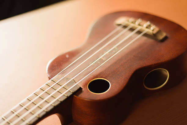 istock Vintage ukulele on wooden table 516010368