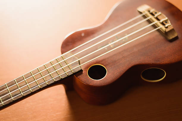 istock Vintage ukulele on wooden table 516010520