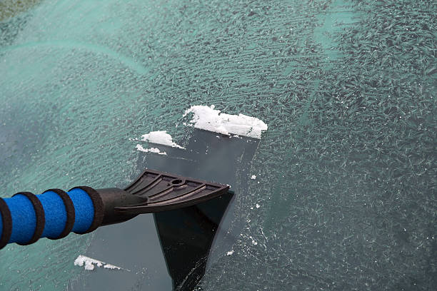 istock Cleaning frost and ice from car window 516010632
