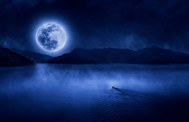 istock One boat run to the full moon  on water skin 516010836