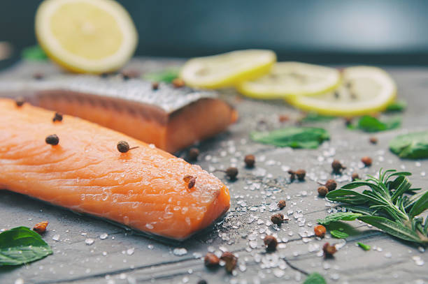 istock Raw Salmon and ingredientsfor cooking on a dark background 516011336