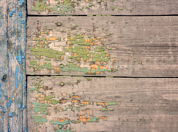 istock Old painted wooden board showing crackled paint 516011568