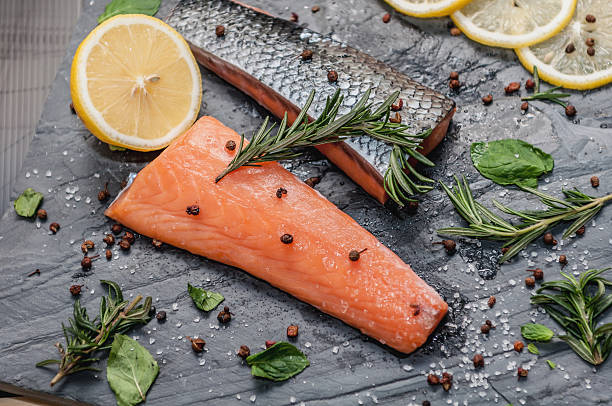 istock Raw Salmon and ingredientsfor cooking on a dark background 516012292
