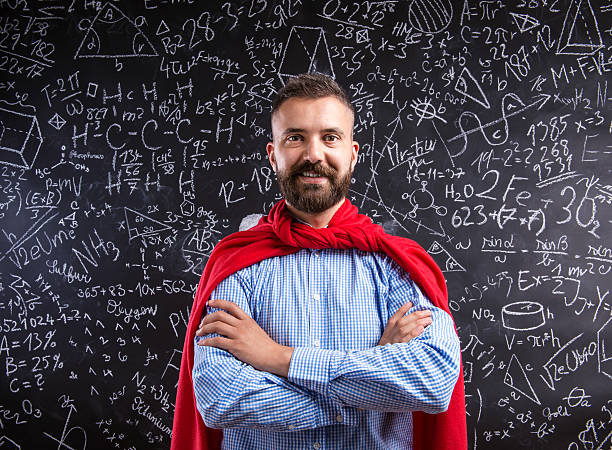 Teacher in red cape against big blackboard with mathematical sym Hipster teacher in red cape standing against big blackboard with mathematical symbols and formulas. Studio shot on black background. math teacher stock pictures, royalty-free photos & images