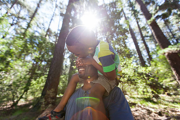 istock African father holding his son on his shoulders 516020753