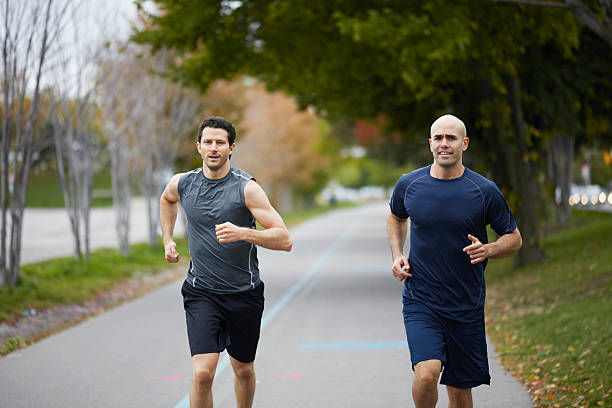 istock Men jogging on footpath in autumn city 516021565