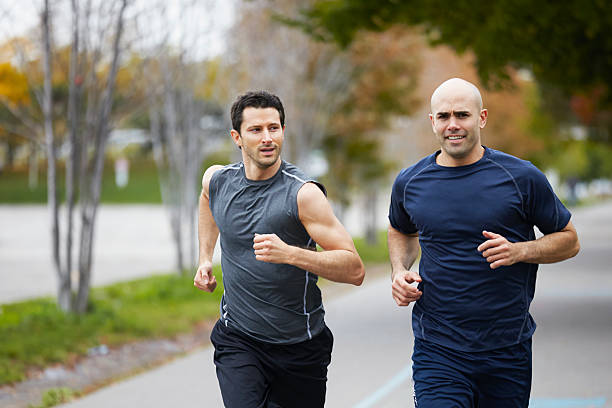 istock Men jogging on footpath in autumn city 516021567