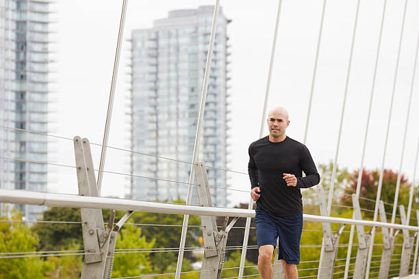 Man jogging on the bridge in autumn city