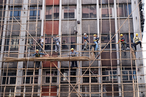 Hong Kong, China - September 18, 2014 : Workers are maintaining old building in Hong Kong.