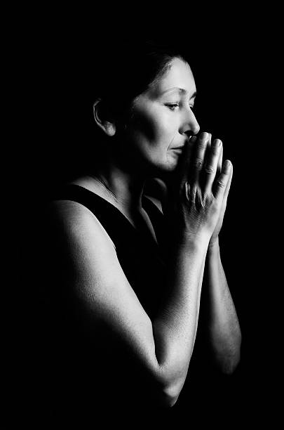 istock Woman prays on a black background 516032956