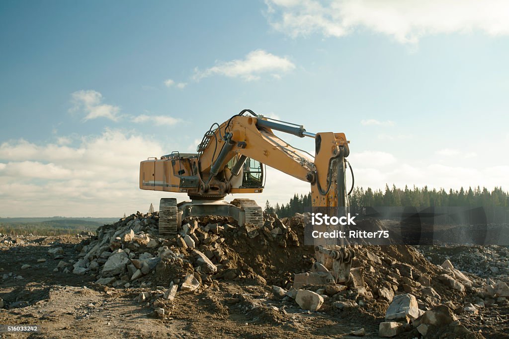 Shovel Excavator Digging Ground Shovel excavator is digging ground in sunny day. Backhoe Stock Photo